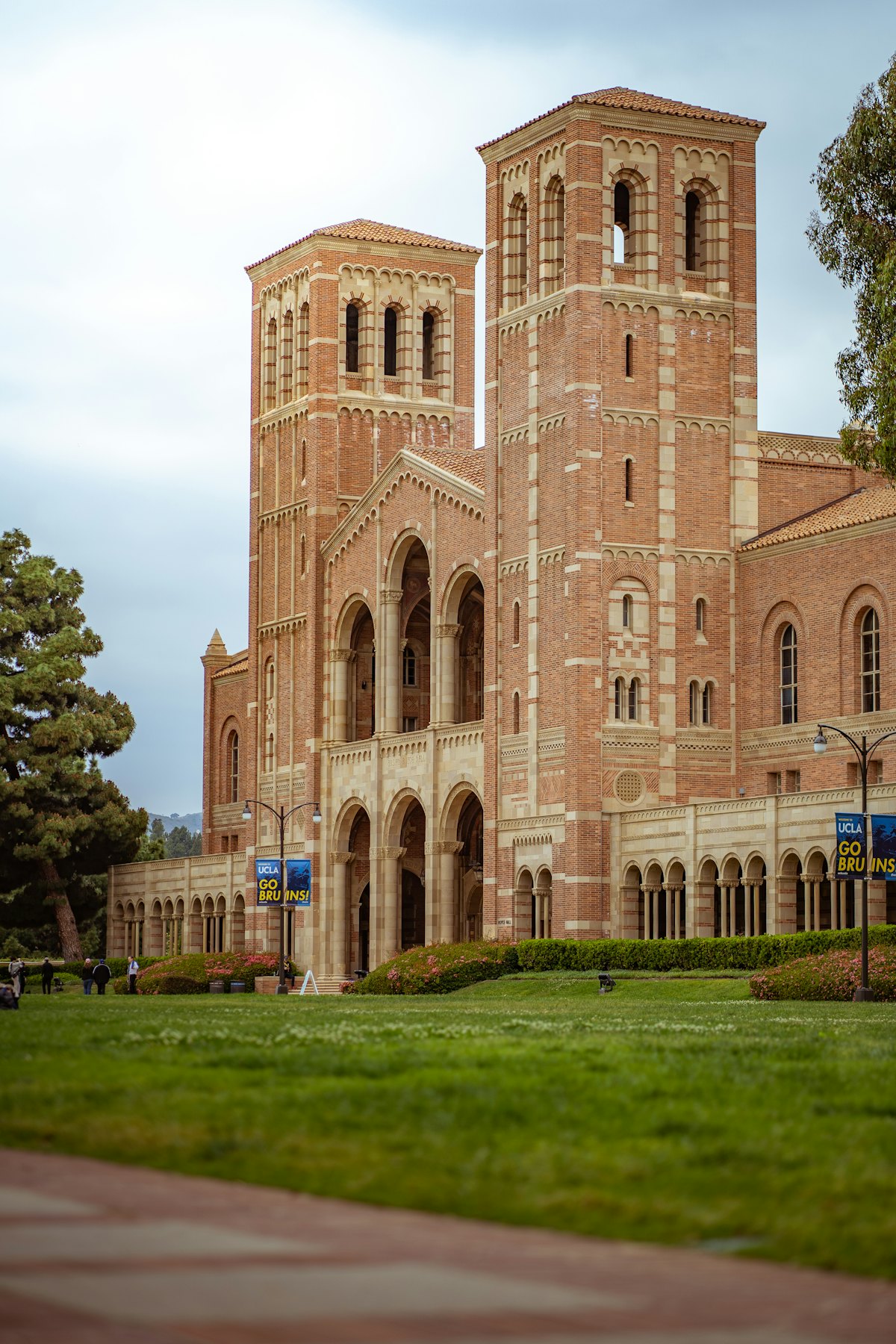 A stone college building with arched windows