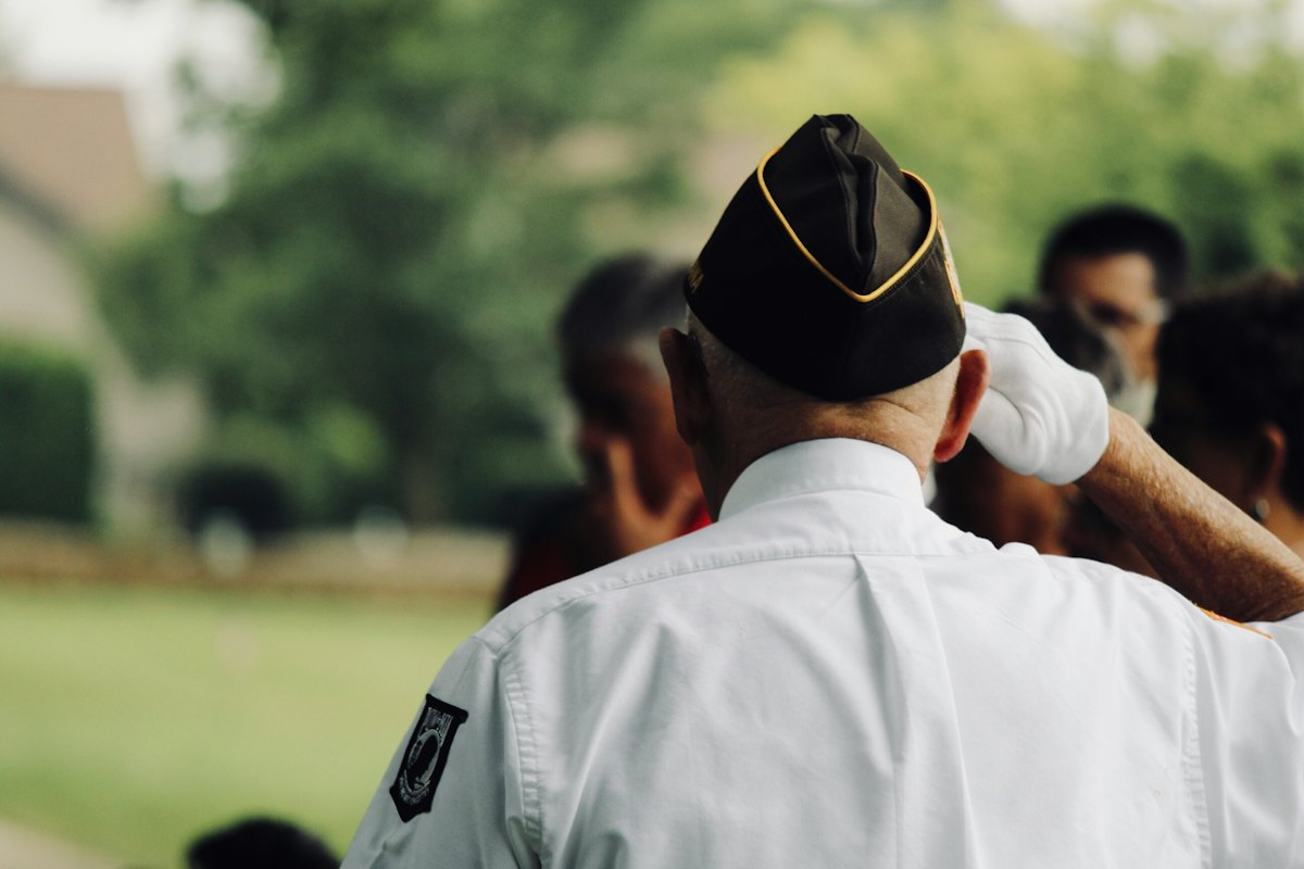 A veteran in a garrison cap standing outdoors