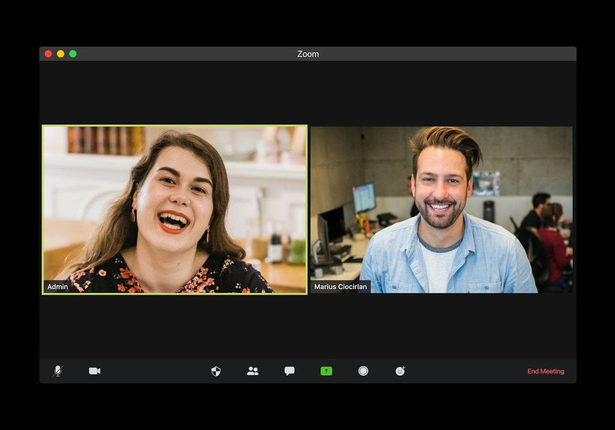 A video call on a laptop screen showing two people