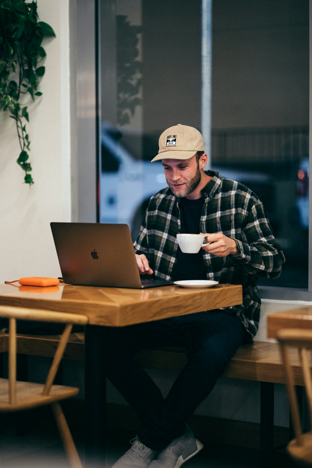 A man working on a laptop at a cafe table