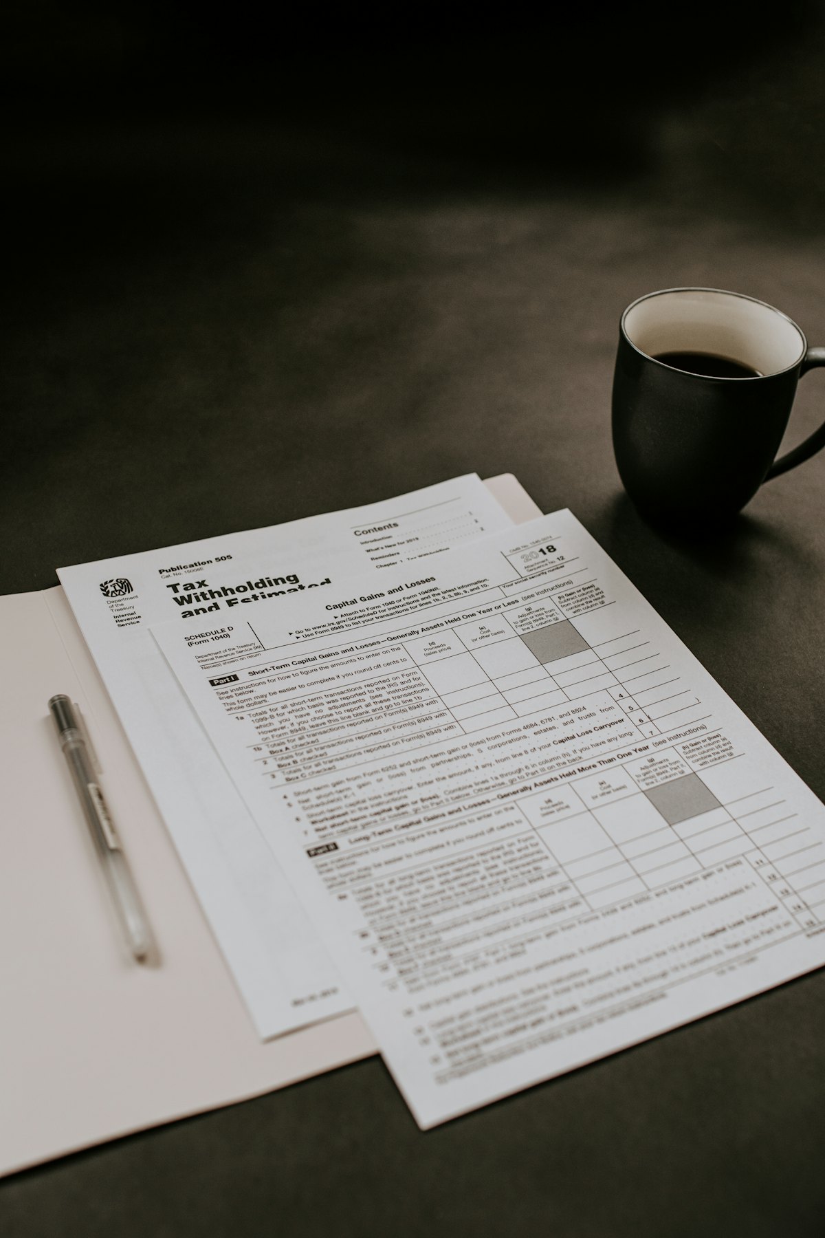 A stack of printed tax forms on a table