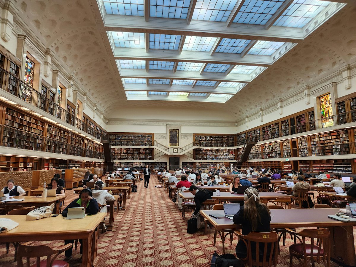 Long reading tables under the high ceiling of a library