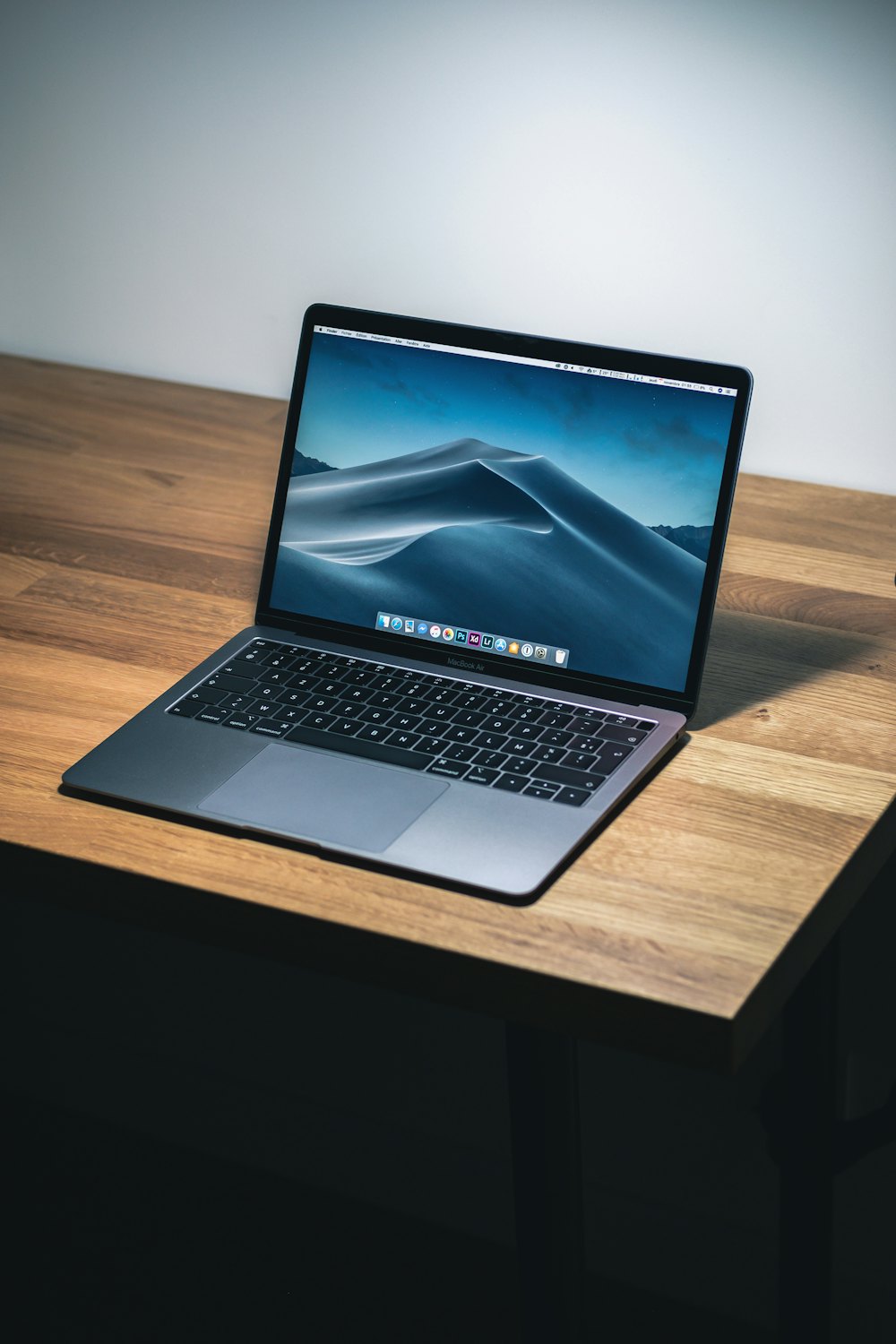 An open laptop on a wooden desk